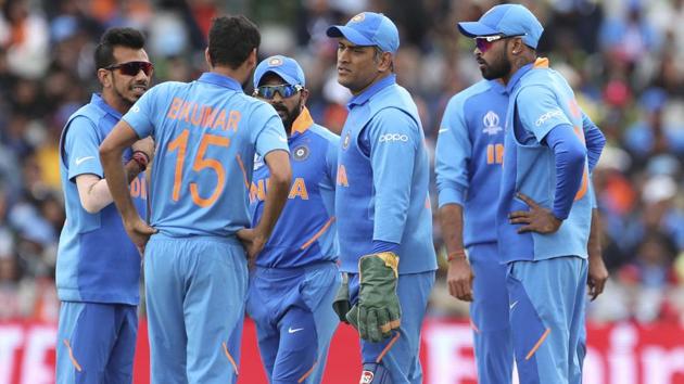 Indian players interact with teammate Bhuvneshwar Kumar, second left, before he left the field. (AP)