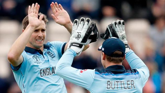 England's Chris Woakes (L) celebrates with England's wicketkeeper Jos Buttler after the dismissal of West Indies' Evin Lewis.(AFP) England's Chris Woakes (L) celebrates with England's wicketkeeper Jos Buttler after the dismissal of West Indies' Evin Lewis.(AFP)