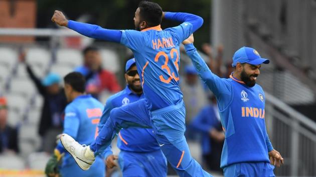 India's Hardik Pandya (C) leaps into the air as he celebrates with teammates after the dismissal of Pakistan's Shoaib Malik. (AFP)