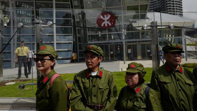 September 2018: A high-speed rail link between Hong Kong and mainland China commenced. Protesters dressed as People’s Liberation Army (PLA) protested outside the Western Kowloon Station in Hong Kong against the opening ceremony of the Hong Kong Express Rail Link as Chinese law was applied in the immigration area. (Vincent Yu / AP File)