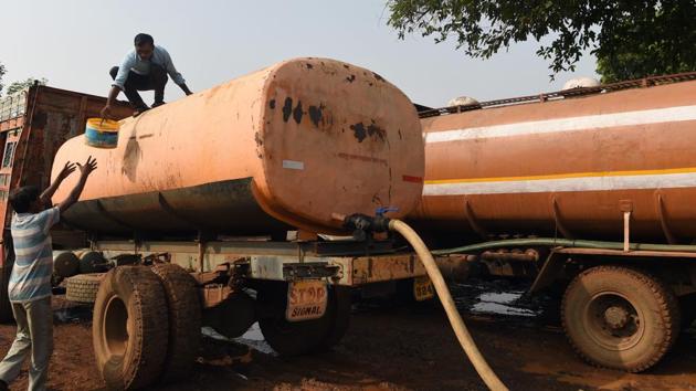 A driver gets a tanker ready to deliver water. Dukre is one of 37 drivers operating government-run water tankers in the area, which is situated around 100 kilometres from India’s financial capital Mumbai. The tankers run seven days a week between March and June, when water is at its scarcest in India. (Punit Paranjpe / AFP)