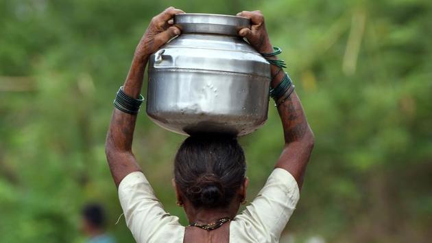 In Shakar Pada village, water levels in the well are dangerously low, meaning villagers are relieved to see Dukre roll in, attach a hose to the back of the tanker and start to fill up everyone’s vessels. “There has been a scarcity of water for the past month,” Pramila Shewale (not pictured) told AFP as she carried a freshly filled pot of water on her head back home. (Punit Paranjpe / AFP)
