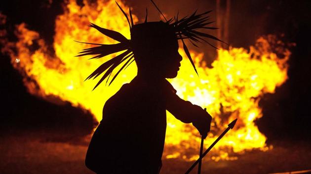 A Rabha priest dances around burning charcoal as part of rituals during Baikho festival at Pantan village, west of Guwahati. Every year, the Rabha community in Assam celebrates the Baikho Puja festival, performing traditional rituals to please a deity of wealth and ask for good rains and a good harvest. (Anupam Nath / AP)