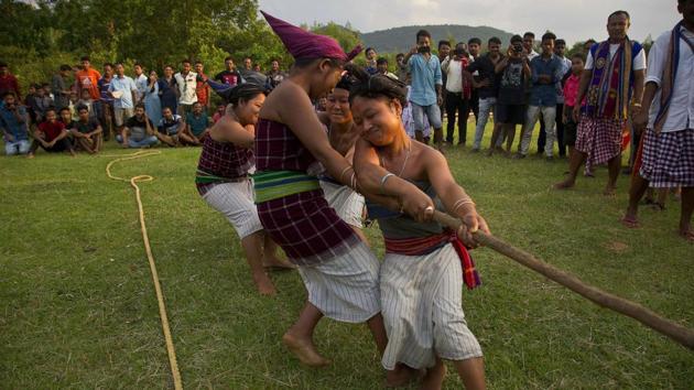 Rabha women participate in a tug of war. After all rituals are finished, people dress up for dances and performances. Villagers from neighbouring communities gather for the all-night celebrations. People play a traditional game known as rope fighting. Men and women play music, dance and sing songs. (Anupam Nath / AP)