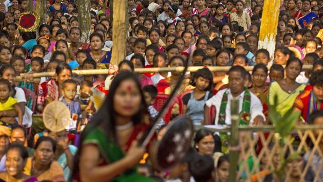 A Rabha woman performs a traditional dance as villagers watch during Baikho festival at Pantan village. (Anupam Nath / AP)
