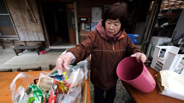Resident Saeko Takahashi sorts trash into a box at her home. In the past, some plastic was exported for recycling, particularly to China, but a ban by Beijing on imports has left plastic recyclables piling up in parts of Japan. Still, not all residents think the initiative could work elsewhere. “It works because we’re only 1,500 people here,” said Yokoyama, who moved from Kyoto. (Kazuhiro Nogi / AFP) 