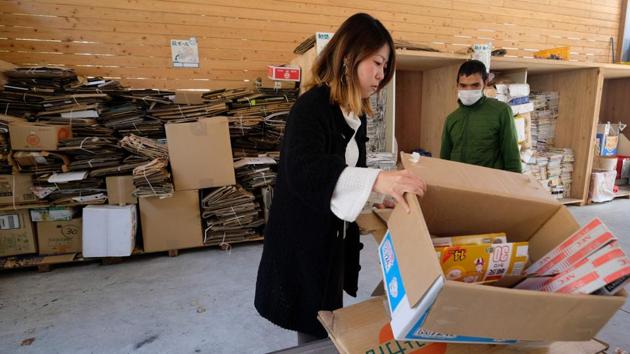 A resident with cardboard waste. Town official Suga said even Kamikatsu will struggle to achieve zero-waste without stronger efforts to reduce consumption. She said: “We have made efforts to achieve zero incineration and zero landfill disposal goals, but it’s not enough.” She explained: “We shouldn’t focus just on how to dispose of trash. We need to come up with policies that prevent the production of waste.” (Kazuhiro Nogi / AFP) 