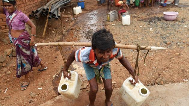 A man carries jerry cans filled with tanker water. Three of the last five monsoons have been deficient and while the IMD is predicting a normal monsoon this year it is already a week late and that worries farmers. “Every year the drought gets worse. I pray to God that there is sufficient water (this time),” Naresh Rera, a 32-year-old farmer, told AFP. (Punit Paranjpe / AFP)