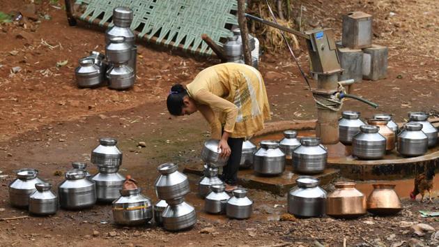 A woman fills stainless steel pots with water. India’s hot season has been particularly harsh this year, with temperatures rising above 50 degrees Celsius in Rajasthan. Almost half of India -- an area home to more than 500 million people -- is facing drought-like conditions because of deficient pre-monsoon rainfall, according to the Indian Meteorological Department (IMD). (Punit Paranjpe / AFP)