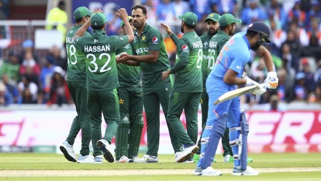 Pakistan's Wahab Riaz, center, celebrates with his teammates taking the wicket of India's K.L. Rahul. (AP)
