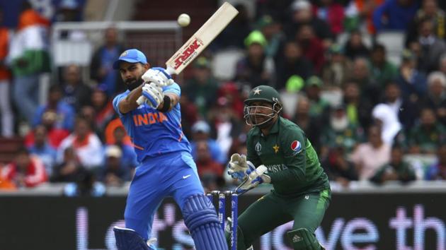 India's captain Virat Kohli, left, plays a shot under the watch of Pakistan's captain Sarfaraz Ahmed. (AP)