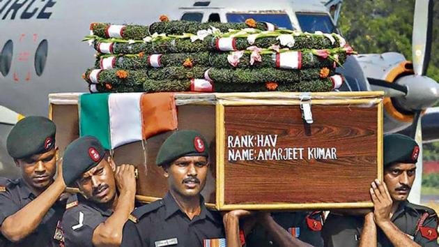 Army personnel carry the coffin of Havildar Amarjeet Kumar, who was killed in improvised Explosive Device (IED) blast on Monday evening in Pulwama district of Jammu and Kashmir, at Jaiprakash Narayan Airport in Patna.(PTI photo)