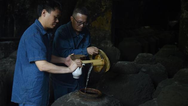 Workers inspect a container filled with baijiu liquor in a cave located in the hills of Luzhou. A wave of “baijiu bars” opened in China, the US, and Europe in recent years as a buzz swelled. But many have since closed. “It’s a challenge for the customers. It hasn’t really caught on in the West yet,” said Demon, Wise & Partners owner Paul Mathew. (Hector Retamal / AFP) Workers inspect a container filled with baijiu liquor in a cave located in the hills of Luzhou. A wave of “baijiu bars” opened in China, the US, and Europe in recent years as a buzz swelled. But many have since closed. “It’s a challenge for the customers. It hasn’t really caught on in the West yet,” said Demon, Wise & Partners owner Paul Mathew. (Hector Retamal / AFP)