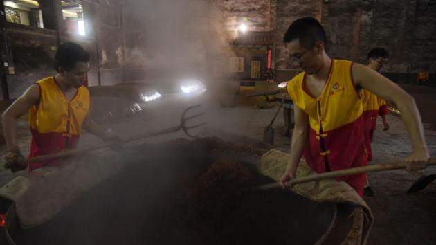 Workers collect the fermented grain. Forced to adapt, manufacturers have found success with milder new varieties and brightly packaged single-serving mixed drinks. Sales have recovered, igniting share prices. In 2017 the market value of Shanghai-listed Kweichow Moutai surged past London-based Diageo, maker of Johnnie Walker whiskey and Smirnoff vodka, to become the world’s most valuable distiller. (Hector Retamal / AFP) Workers collect the fermented grain. Forced to adapt, manufacturers have found success with milder new varieties and brightly packaged single-serving mixed drinks. Sales have recovered, igniting share prices. In 2017 the market value of Shanghai-listed Kweichow Moutai surged past London-based Diageo, maker of Johnnie Walker whiskey and Smirnoff vodka, to become the world’s most valuable distiller. (Hector Retamal / AFP)