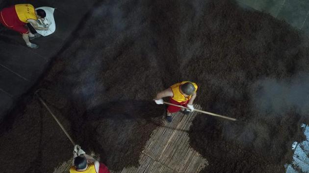 Workers prepare grain on a work floor. Baijiu has been on a roller-coaster in recent years. A government corruption crackdown launched in 2012 hit hard: premium brands had become the go-to gift for bribing Communist officials. Sales fell off a “cliff,” Su said. And many younger Chinese, exposed to French wine and German beer, shun a rotgut they equate with rural regions and drunken businessmen. (Hector Retamal / AFP) Workers prepare grain on a work floor. Baijiu has been on a roller-coaster in recent years. A government corruption crackdown launched in 2012 hit hard: premium brands had become the go-to gift for bribing Communist officials. Sales fell off a “cliff,” Su said. And many younger Chinese, exposed to French wine and German beer, shun a rotgut they equate with rural regions and drunken businessmen. (Hector Retamal / AFP)