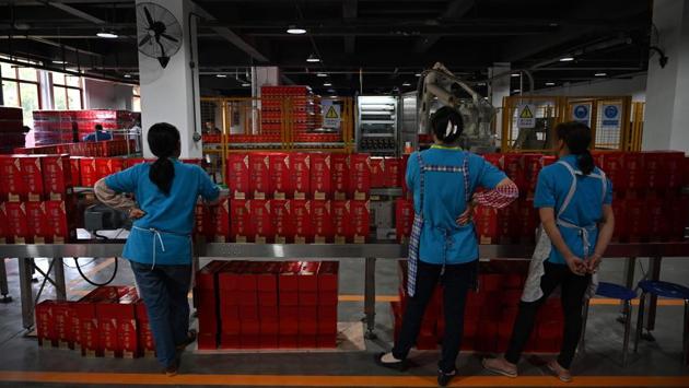 Employees inspect baijiu liquor on a production line at the Luzhou Loajian bottling plant. The price of top brands is one hurdle. Mathew charges 12 pounds ($15) for a glass of Kweichow Moutai. “It is also a very unfamiliar flavour for guests, so we need to tell them the story, how baijiu is made, why it has the characteristics it has, before it becomes more accessible,” he said. (Hector Retamal / AFP) Employees inspect baijiu liquor on a production line at the Luzhou Loajian bottling plant. The price of top brands is one hurdle. Mathew charges 12 pounds ($15) for a glass of Kweichow Moutai. “It is also a very unfamiliar flavour for guests, so we need to tell them the story, how baijiu is made, why it has the characteristics it has, before it becomes more accessible,” he said. (Hector Retamal / AFP)