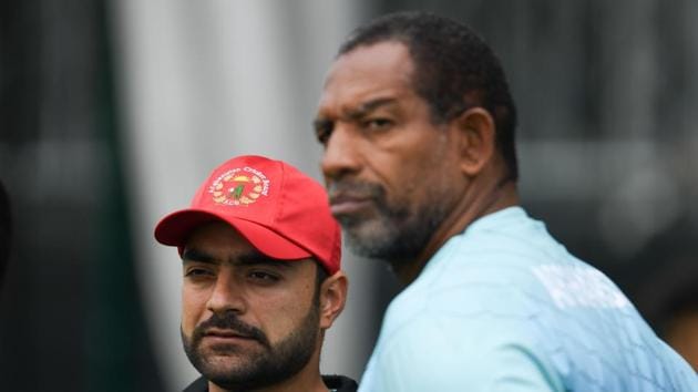 Afghanistan's Rashid Khan (L) and Afghanistan's head coach Phil Simmons (R) attend a training session.(AFP)