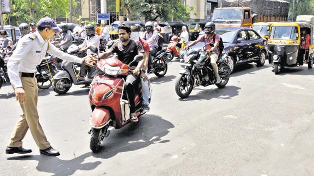 The Pune police from January to May this year have generated a total revenue of at least Rs 45 crore from helmet-less drive campaign by implementing the rule. (HT PHOTO) The Pune police from January to May this year have generated a total revenue of at least Rs 45 crore from helmet-less drive campaign by implementing the rule. (HT PHOTO)