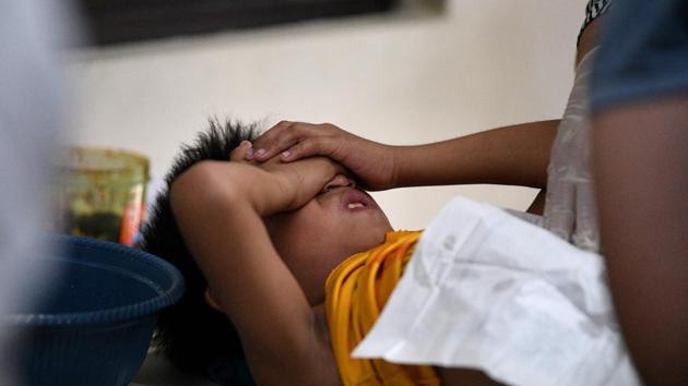 A boy covers his eyes while being circumcised at a village health centre in Manila. Every year, thousands of pre-teens from poor families go through the operation for free at government or community-sponsored clinics. “I was shouting the whole time because it hurt so bad,” Vladimir Vincent Arbon told AFP after his 20-minute ordeal. (Noel Celis / AFP)