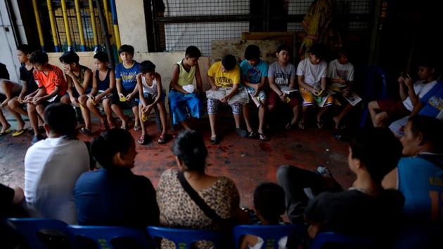 Boys wait their turn to be circumcised at a village health centre in Manila. “My mum told me that I need to get circumcised so I would grow taller and become a real man,” the 11-year-old Arbon added, expressing the pressure many youths face. He was among 1,500 boys who underwent the procedure in one city near Manila, but the scenes are similar in clinics nationwide. (Noel Celis / AFP)