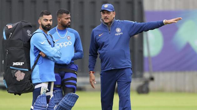 Indian team coach Ravi Shastri, right, interacts with captain Virat Kohli, left, and Hardik Pandya during a training session ahead of their Cricket World Cup match against Afghanistan(AP)