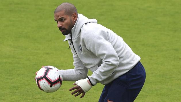 India's Shikhar Dhawan holds a soccer ball during a training session.(AP)