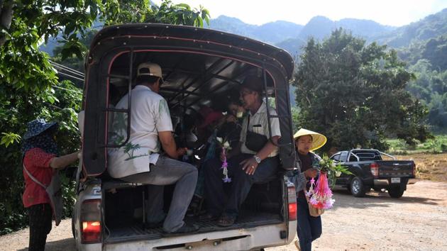 Visitors boarding a shuttle car to take them to the entrance of the Tham Luang cave. When they emerged -- after being heavily sedated and manoeuvred out by expert divers -- they did so into the centre of a global media frenzy. The cave, which previously received around 5,000 visitors a year, has since been inundated by visitors both Thai and foreign. (Lilian Suwanrumpha / AFP)