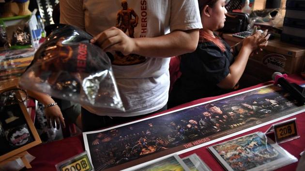 Vendors selling memorabilia, illustrating the rescue of the 12 boys. Kraingkrai Kamsuwan, 60, who moved his stall to the site weeks after the rescue, sells 4,000 tickets a month ($2.5) but reckons more will visitors will arrive once the cave reopens. He told AFP: “People want to gamble after wishing for luck from the shrine.” (Lilian Suwanrumpha / AFP)