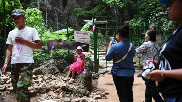 Visitors taking photos near the entrance of the Tham Luang cave. “It’s amazing what happened here. I followed everything from Australia,” tourist John McGowan told AFP after taking photos at the visitor centre around 100 metres from the Tham Luang cave entrance. “I wanted to see it with my own eyes,” the 60-year-old said, adding he was a little disappointed the cave is still off limits to visitors. (Lilian Suwanrumpha / AFP)