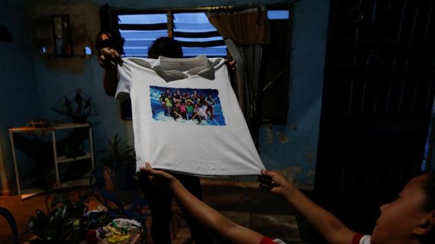 Relatives of Maroly Bastardo, show one of her t-shirts at their home. For Bastardo, the grinding hardships of life in Venezuela loomed as the greater danger. She was feeling exhausted and increasingly anxious about her health and of her baby in the event of a difficult labor. “Things are too rough here girl,” Bastardo texted an aunt in the days leading up to her departure from Venezuela. (Ivan Alvarado / REUTERS) Relatives of Maroly Bastardo, show one of her t-shirts at their home. For Bastardo, the grinding hardships of life in Venezuela loomed as the greater danger. She was feeling exhausted and increasingly anxious about her health and of her baby in the event of a difficult labor. “Things are too rough here girl,” Bastardo texted an aunt in the days leading up to her departure from Venezuela. (Ivan Alvarado / REUTERS)