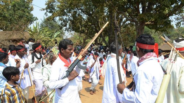 File photo of tribal leader with traditional weapons attending the gram sabha before unveiling of the stone of Pathalgarhi in Khunti, Jharkhand.(HT File Photo)