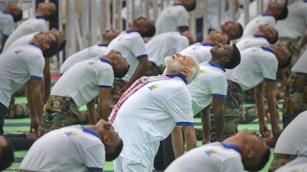 Prime Minister Narendra Modi performs yoga during a mass yoga event on the 5th International Day of Yoga at Prabhat Tara ground, in Ranchi on Friday. (PTI Photo/Kamal Kishore)