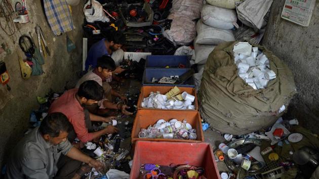 Workers sorting plastic at a factory in Dharavi. “Dharavi is the beating heart of Mumbai... The government wants to grab it,” says liquid soap manufacturer Ashraf Sheikh who recently went on an eight-day hunger strike over the redevelopment. Estimates vary but between 700,000 and one million people cram into tiny homes on the 520-acre site; hundreds queue up to use public washrooms. (Punit Paranjpe / AFP)