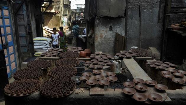 Newly made pots kept for drying in Dharavi, Fifteen-year-old Muskan Sheikh is excited by the prospect. She lives in a bathroom-less one-room house with five relatives sleeping head-to-toe. Many Dharavi residents are sceptical, however. They would welcome new homes with private bathrooms and running water but worry that the intrinsic nature of Dharavi, where people live and work out of the same room, will disappear. (Punit Paranjpe / AFP)