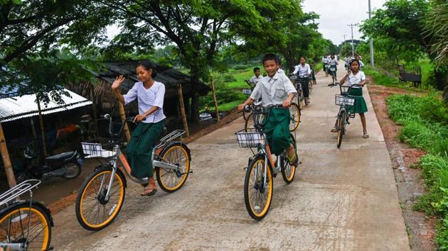 Thae Su Wai will no longer need to trudge 10 kilometres for two hours to and from lessons, she told AFP, beaming. “I’ll have more time to study and play with friends,” she said, as she excitedly wheeled away her new bicycle at Nhaw Kone Village school near Yangon. (Ye Aung Thu / AFP)