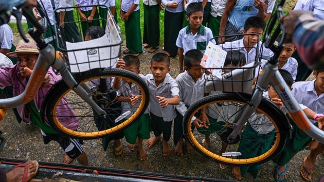 Children aged 13-16 living more than two kilometres from school will be at the front of the queue. “Most parents here are poor,” says Ni Ni Win, 55, headteacher of Thae Su Wai’s school. “Many children don’t even have umbrellas -- they just use pieces of plastic to cover them when it rains.” (Ye Aung Thu / AFP)