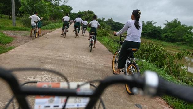 Mike says this is just the start -- the aim is to keep up momentum and hand out a total of 100,000 bikes over five years. “They might not be worth anything in Singapore, but they’re valuable in a poorer country,” he said. (Ye Aung Thu / AFP)