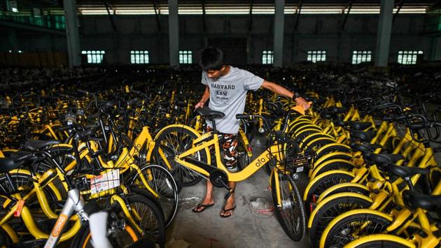 UNICEF estimates 55% of children in Myanmar live in poverty, while half of 17-year-olds enter adulthood with little or no education. So when Mike heard that bike-sharing companies oBike, Ofo and Mobike had pulled out from Singapore and Malaysia, leaving thousands of cycles in “graveyards”, he grabbed his chance. (Ye Aung Thu / AFP)