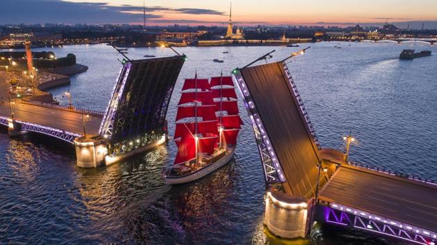 A brig with scarlet sails travels through the Dvortsovy (Palace) drawbridge rising above the Neva River during a rehearsal for the Scarlet Sails festivities marking school graduation which will take place on June 24 in St. Petersburg, Russia. (Dmitri Lovetsky / AP)