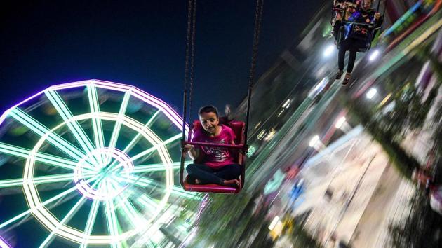A girl enjoys a swing carousel ride at an amusement park in Mazar-i-Sharif, Afghanistan. (Farshad Usyan / AFP)