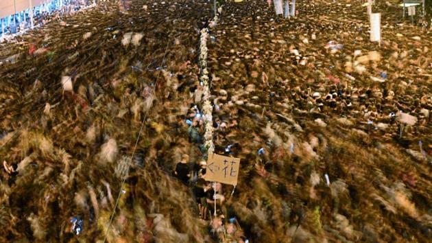 A slow shutter image shows thousands of protesters taking part in a new rally against the controversial extradition law proposal in Hong Kong. Protesters choked Hong Kong’s streets in a defiant rebuke of the extradition law, piling pressure on the city’s embattled pro-Beijing leader despite a weekend climbdown. (Hector Retamal / AFP)