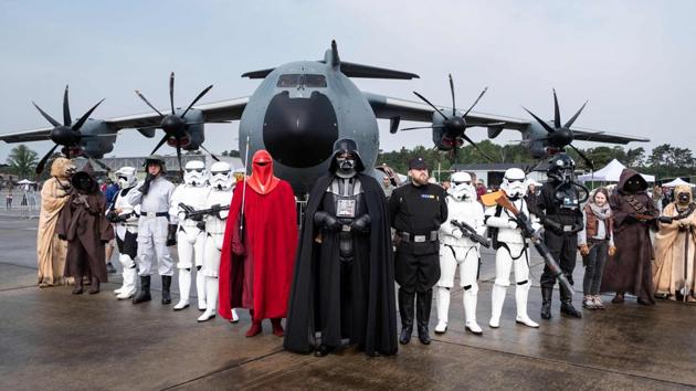 Visitors in Star Wars costumes pose in front of a Herkules plane during the “Tag der Bundeswehr” (Day of the German Armed Forces) at the air base in Fassberg, northern Germany. (Peter Steffen / dpa / AFP)