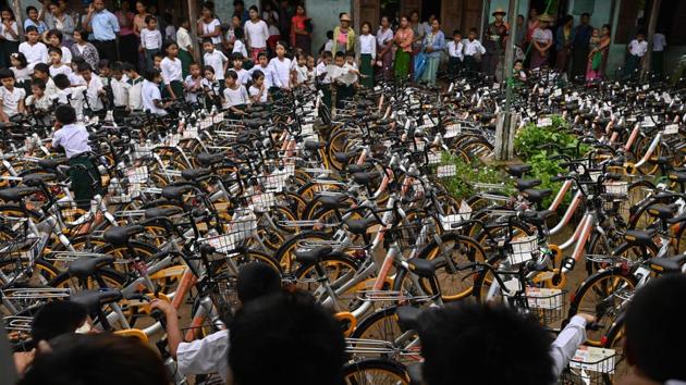 Students look at bicycles shipped from Singapore, which have been donated as part of the "Lesswalk" scheme at a school on the outskirts of Yangon. Mike hopes they will help keep more kids in school for longer, giving them an education so they can “escape from poverty”. Yangon is Lesswalk’s first stop before Mike rolls out the scheme in Mandalay and Sagaing regions later this month. (Ye Aung Thu / AFP)