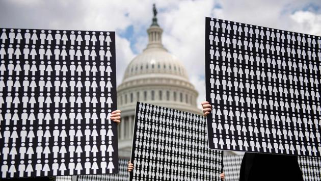 Demonstrators hold up placards representing the number of the people who have died due to gun violence on Capitol Hill in Washington, DC, USA, during an event with gun violence prevention advocates. (Jim Watson / AFP)