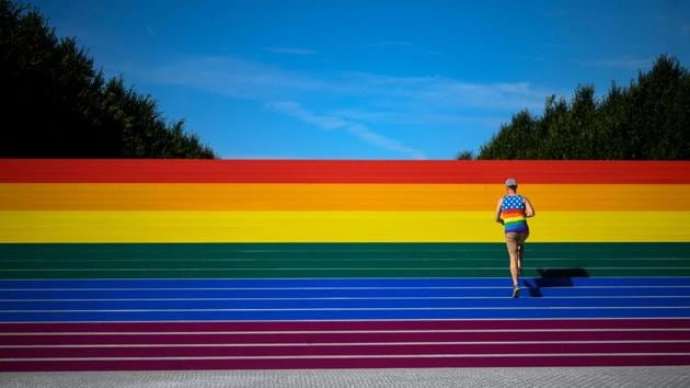 A man walks on steps covered in rainbow colours for Pride Month at Franklin D. Roosevelt Four Freedoms Park in New York City. Organizers claim it is the largest LGBT pride flag in New York City and measures around 12 by 100 feet. (Johannes Eisele / AFP)