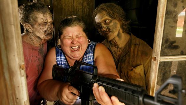 Tourist Amy Powers is approached by “Walker” Matthew Tomlin during The Walking Dead Tour of a Season 3 location of the AMC production in Haralson, Georgia, USA. (Chris Aluka Berry / REUTERS)