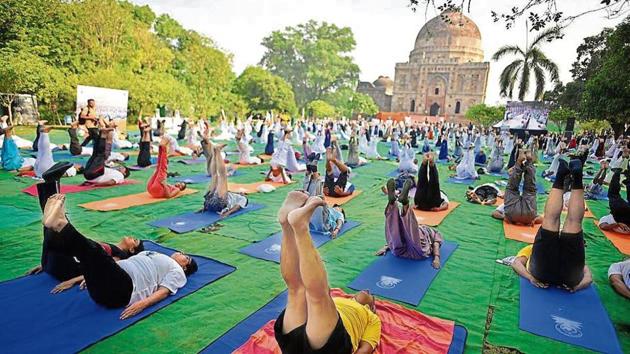 In several parts of the city, government officials, students, senior citizens and women celebrated yoga day by collectively performing asanas (poses).(HT Photo)