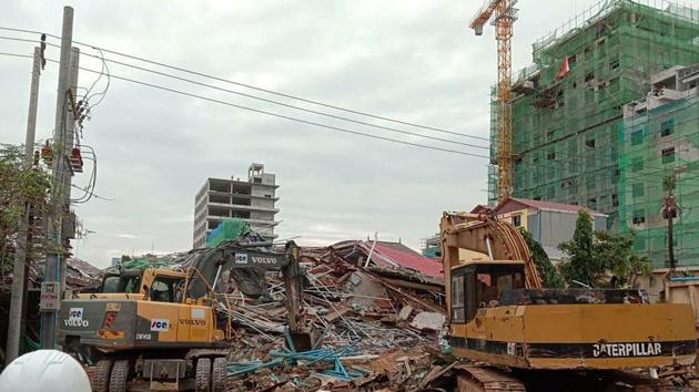 In this photo provided by Cambodia National Police, backhoes work near a site of a collapse in Preah Sihanouk province, Cambodia Saturday, June 22, 2019. A seven-story building under construction collapsed, killing at least a few workers, authorities said. (Cambodia National Police via AP) In this photo provided by Cambodia National Police, backhoes work near a site of a collapse in Preah Sihanouk province, Cambodia Saturday, June 22, 2019. A seven-story building under construction collapsed, killing at least a few workers, authorities said. (Cambodia National Police via AP)
