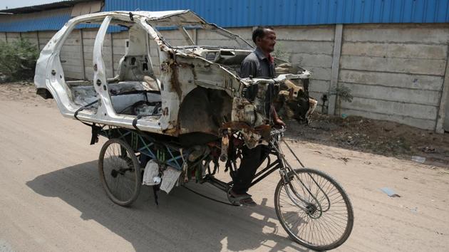 A man carries a dismantled car on a cycle rickshaw to a scrapyard in Ahmedabad, Gujarat. (Amit Dave / REUTERS) A man carries a dismantled car on a cycle rickshaw to a scrapyard in Ahmedabad, Gujarat. (Amit Dave / REUTERS)