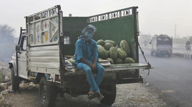 A water melon vendor sits with his face covered during a dust storm in Jammu city, Jammu and Kashmir. (Channi Anand / AP) A water melon vendor sits with his face covered during a dust storm in Jammu city, Jammu and Kashmir. (Channi Anand / AP)